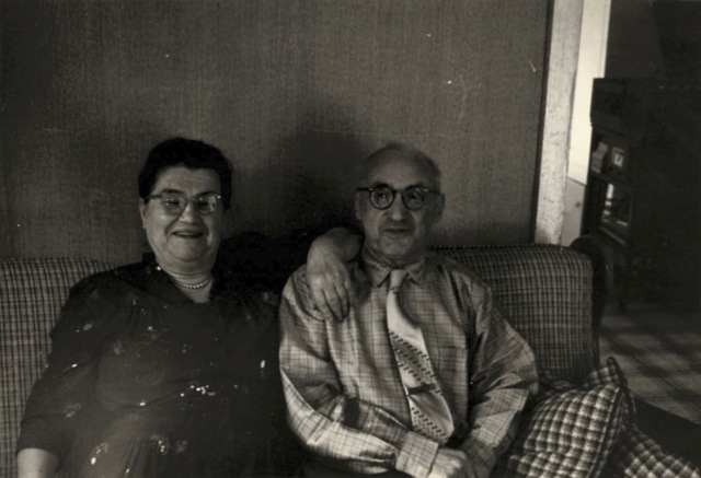Photo of Sonia and Jerome, sitting on a couch together, smiling